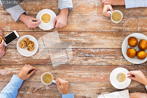 Image of close up of business team drinking coffee on lunch