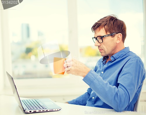 Image of man working with laptop at home