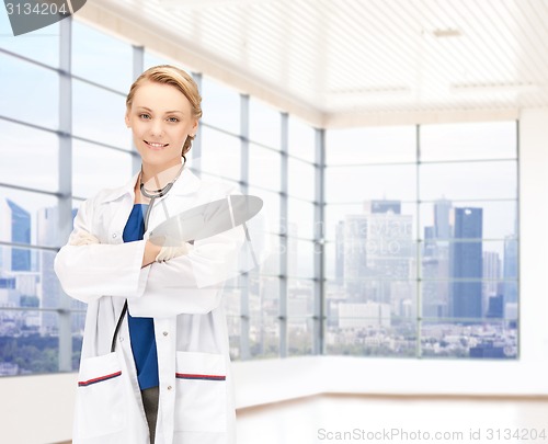 Image of smiling young female doctor in white coat