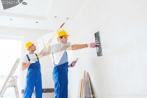 Image of group of builders with tools indoors