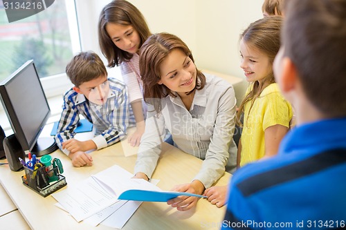 Image of group of school kids with teacher in classroom