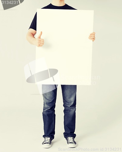 Image of man showing white blank board and thumbs up