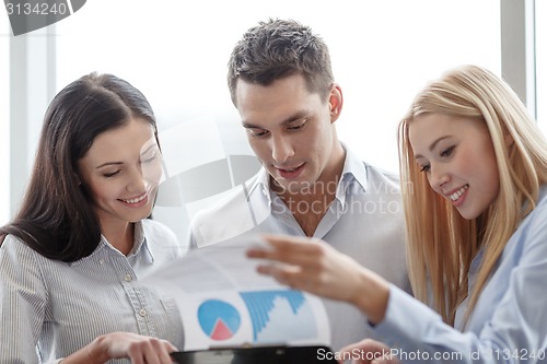 Image of business team looking at clipboard