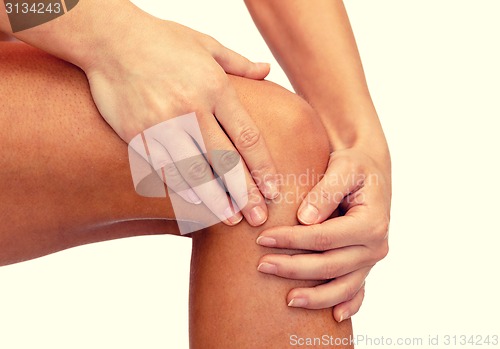 Image of close up of female hands holding knee