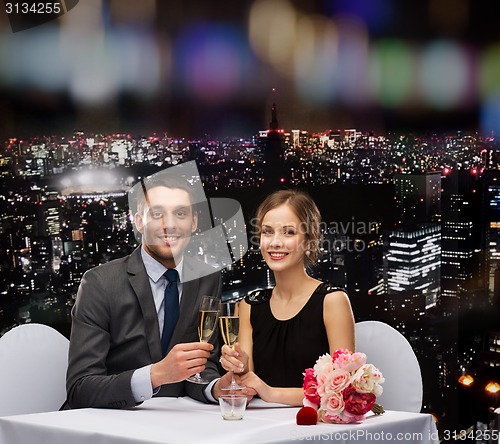 Image of couple with glasses of champagne at restaurant