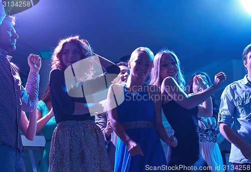 Image of group of happy friends dancing in night club