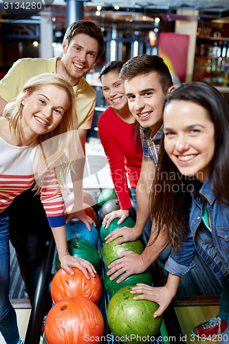 Image of happy friends in bowling club