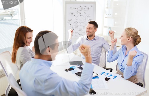 Image of smiling business people meeting in office