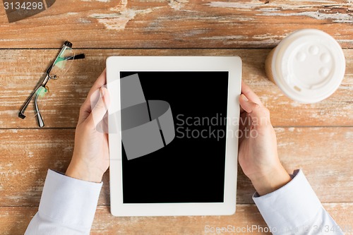 Image of close up of female hands with tablet pc and coffee