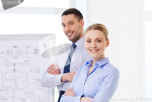 Image of smiling business people in office