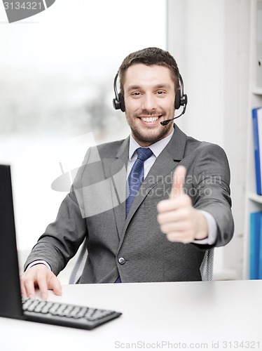 Image of helpline operator with headphones and computer