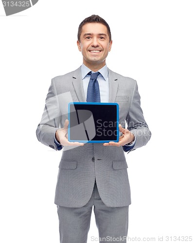 Image of happy businessman in suit showing tablet pc screen