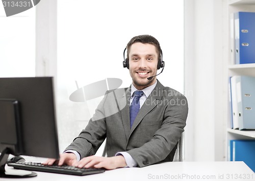 Image of helpline operator with headphones and computer