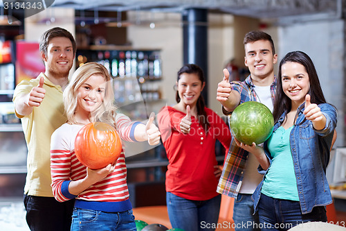 Image of happy friends in bowling club