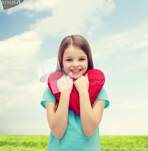Image of smiling little girl with red heart