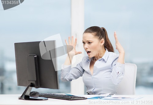 Image of stressed woman with computer