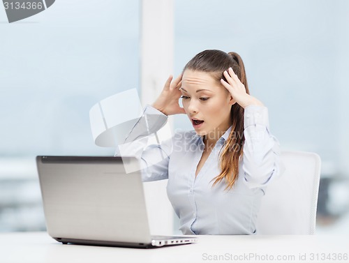 Image of stressed woman with laptop