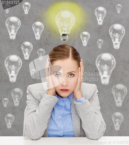 Image of stressed woman covering her ears with hands