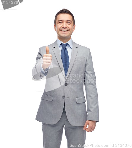 Image of happy businessman in suit showing thumbs up