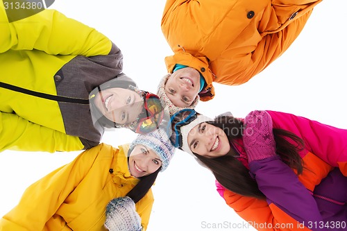 Image of happy friends in ski goggles outdoors