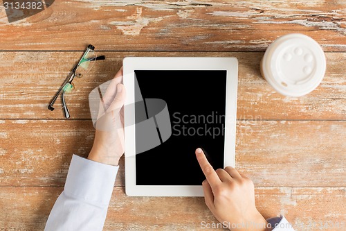 Image of close up of female hands with tablet pc and coffee