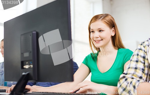 Image of smiling female student in computer class