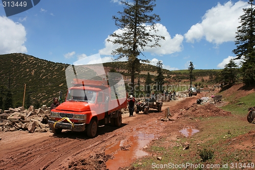 Image of Trucks on muddy road