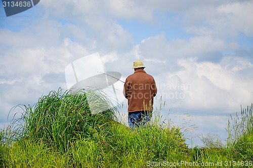 Image of Fisherman in anticipation of the catch  with a fishing rod on th