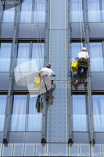 Image of Two climbers wash windows