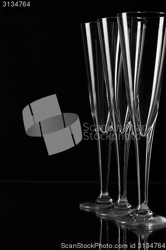 Image of Three champagne glasses on a glass plate