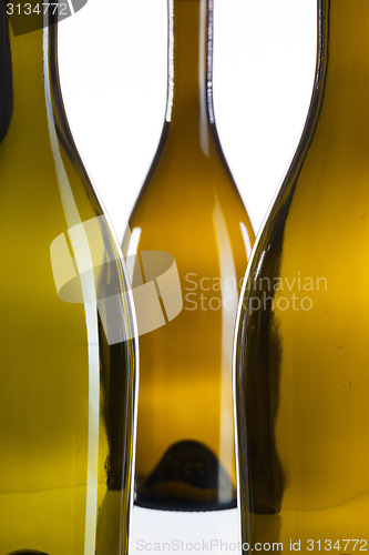 Image of Detail of three empty wine bottles 