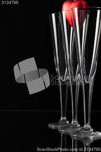 Image of Three champagne glasses and red heart