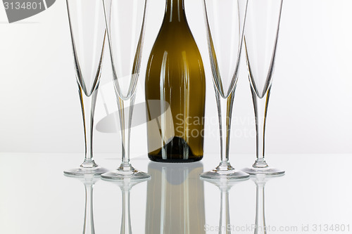 Image of Four  champagne glasses on a glass table