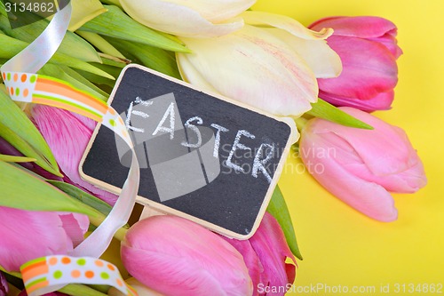 Image of Easter ribbon, tulips and small chalkkboard