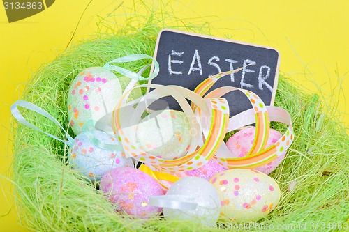 Image of Ester eggs in nest with copy-space blackboard