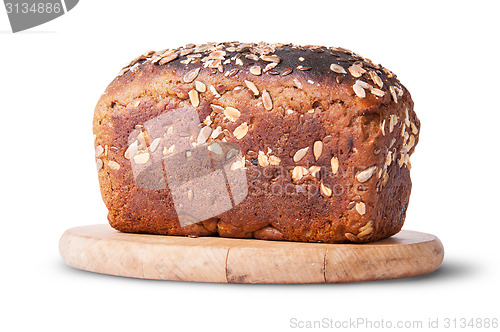 Image of Unleavened bread with seeds and dried fruit on wooden board