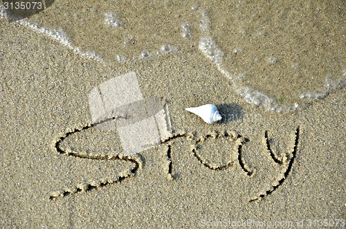 Image of STAY word on the beach. 