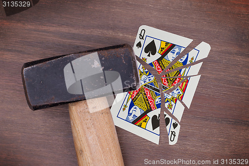 Image of Hammer with a broken card, queen of spades