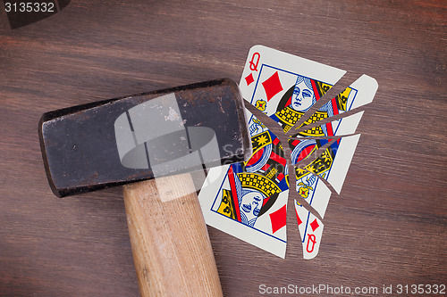 Image of Hammer with a broken card, queen of diamonds