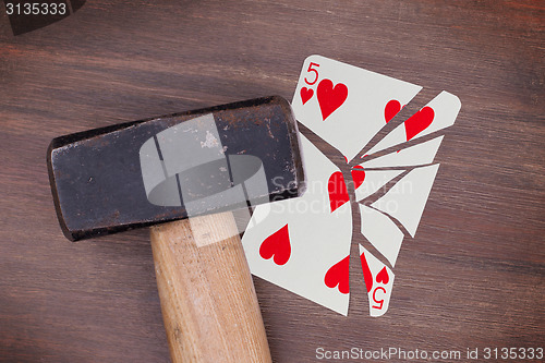 Image of Hammer with a broken card, five of hearts