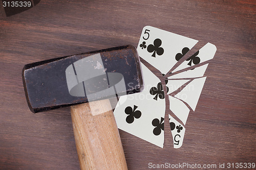 Image of Hammer with a broken card, five of clubs