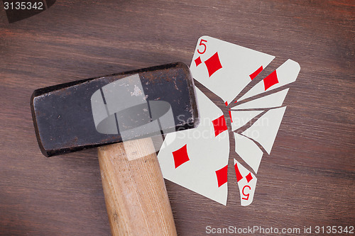 Image of Hammer with a broken card, five of diamonds