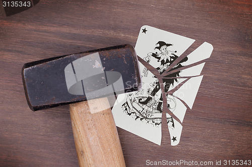 Image of Hammer with a broken card, joker