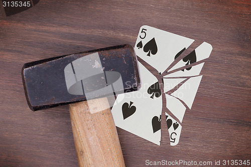 Image of Hammer with a broken card, five of spades