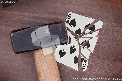 Image of Hammer with a broken card, eight of spades