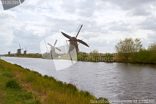 Image of Traditional dutch windmill near the canal. Netherlands