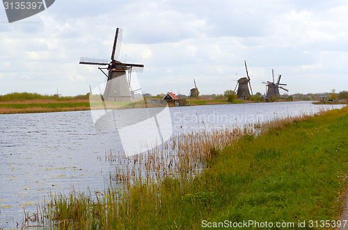 Image of Traditional dutch windmill near the canal. Netherlands