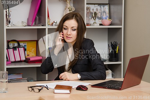 Image of employee of the office carrying a conversation on phone