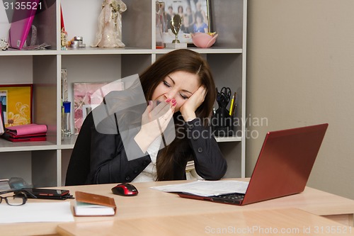 Image of Office worker yawning in front of computer