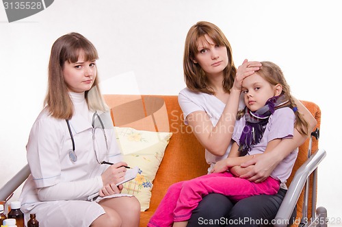 Image of Pediatrician visits a sick child at home